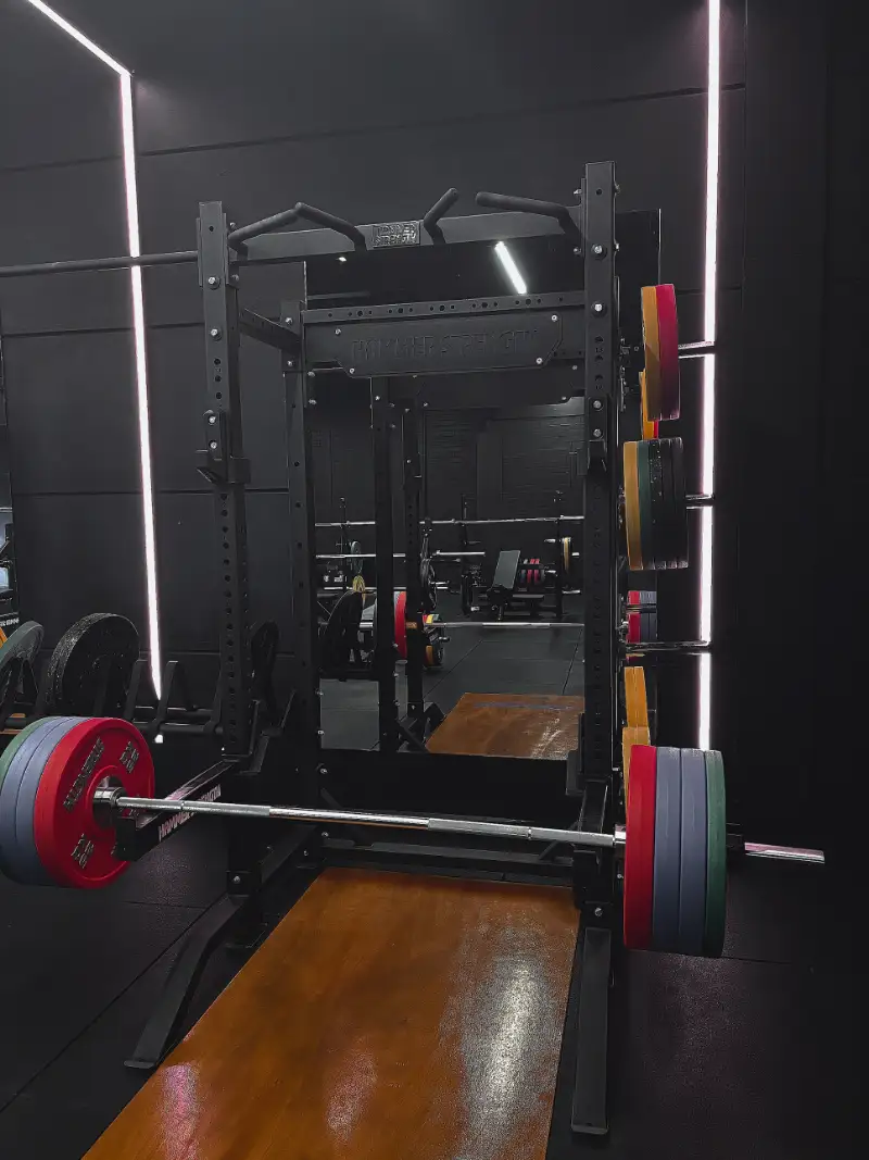 Loaded barbell on a squat rack